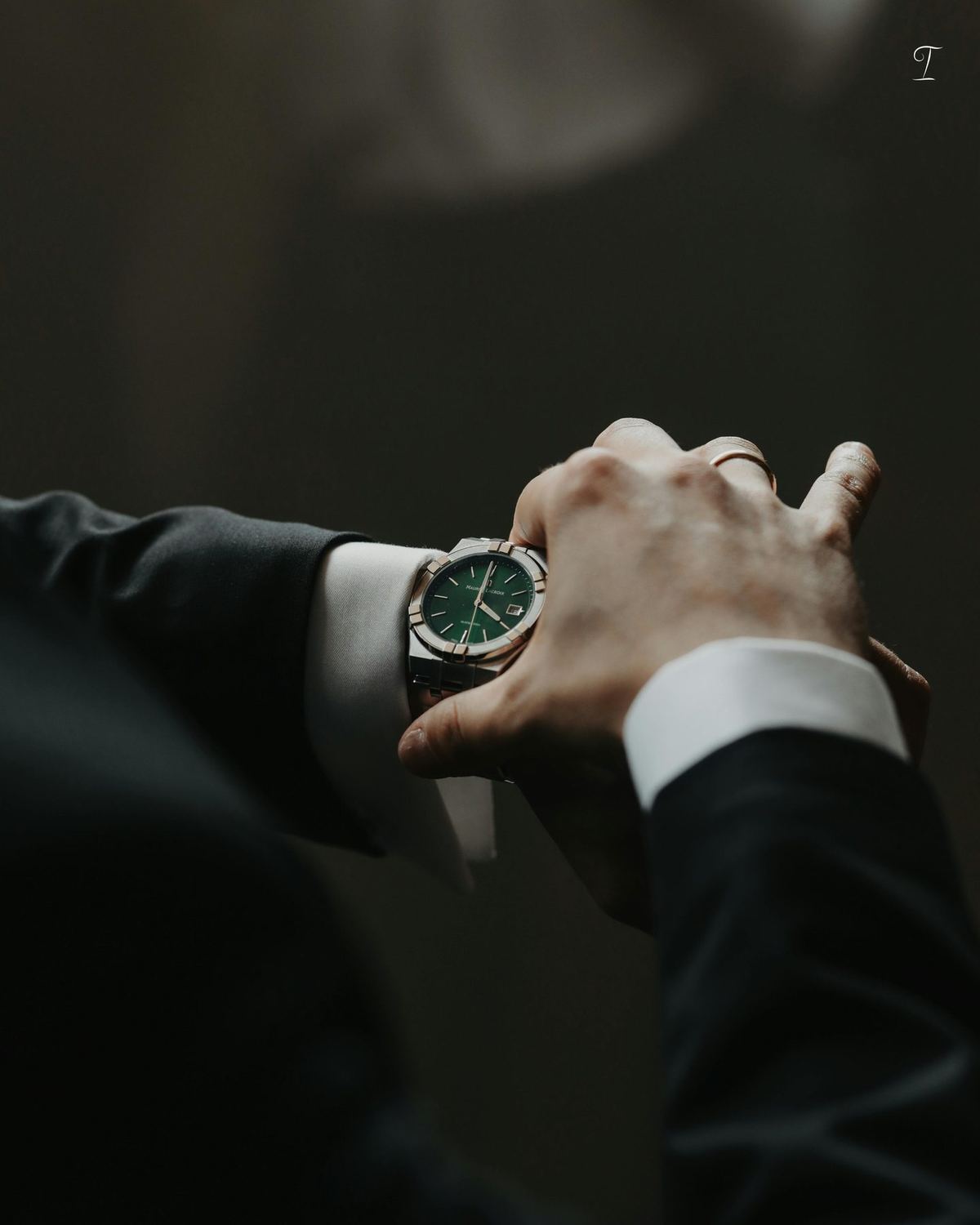 Suited hand adjusting a watch, for SIGND talent management