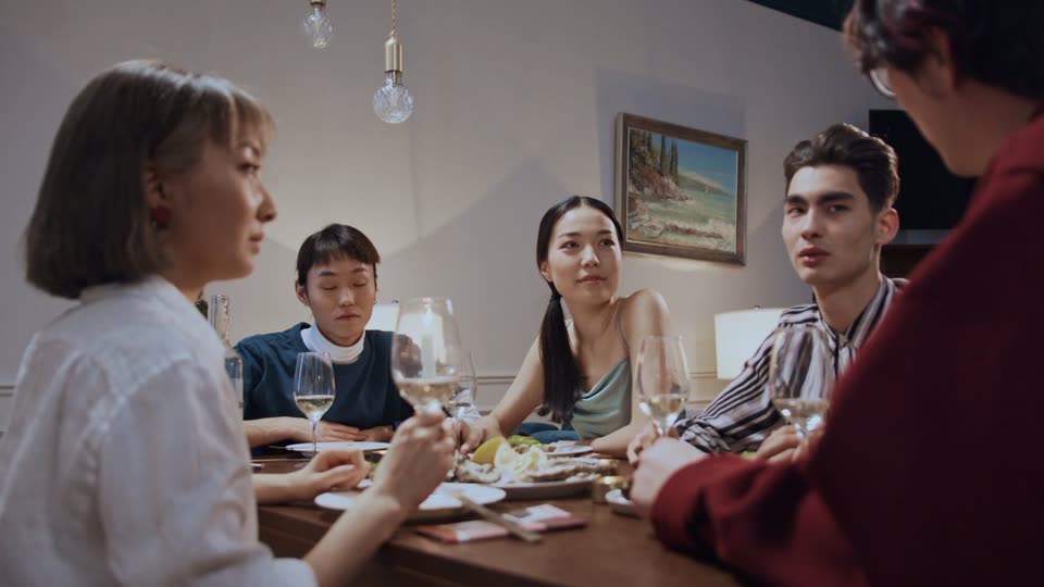Friends talking around a dinner table at a SafeSpace circle